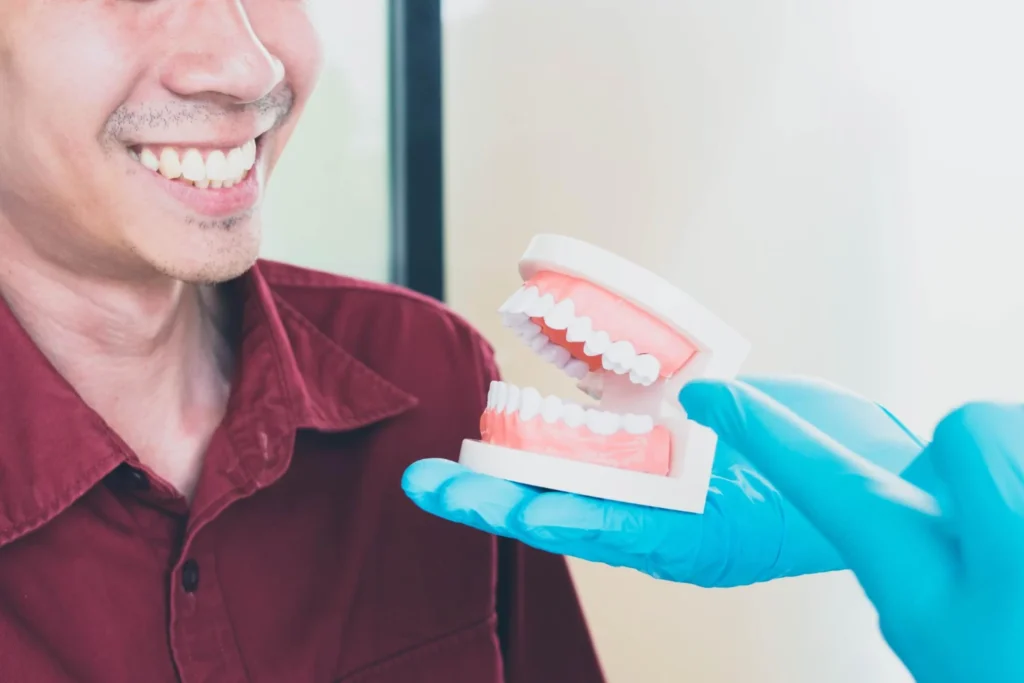 Dentiste préparant le rescellement d'une couronne dentaire décollée au cabinet Almé.